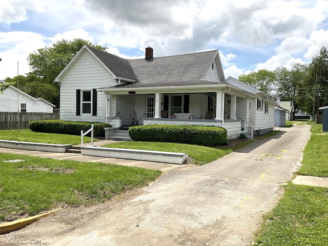 357 S Main St, Spencer, IN 47460 - view of front of home featuring a chimney, a porch, and roof with shingles