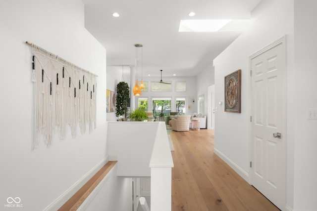 3781 S Station Dr, Columbus, IN 47203 - hallway featuring recessed lighting, light wood finished floors, an upstairs landing, a skylight, and baseboards
