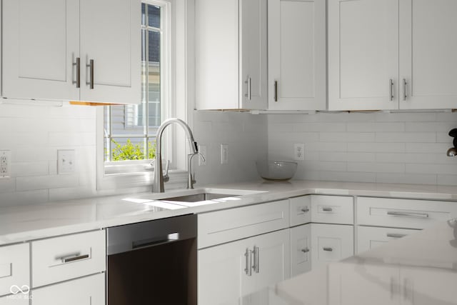 3781 S Station Dr, Columbus, IN 47203 - kitchen featuring stainless steel dishwasher, a sink, backsplash, and white cabinets