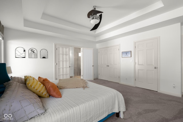 3781 S Station Dr, Columbus, IN 47203 - bedroom featuring a tray ceiling, carpet flooring, and baseboards