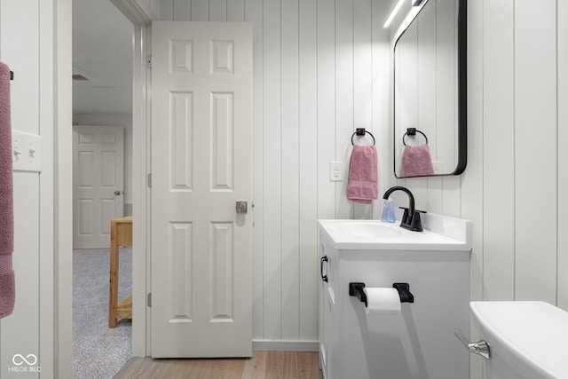 3781 S Station Dr, Columbus, IN 47203 - half bath featuring wood finished floors, vanity, and toilet