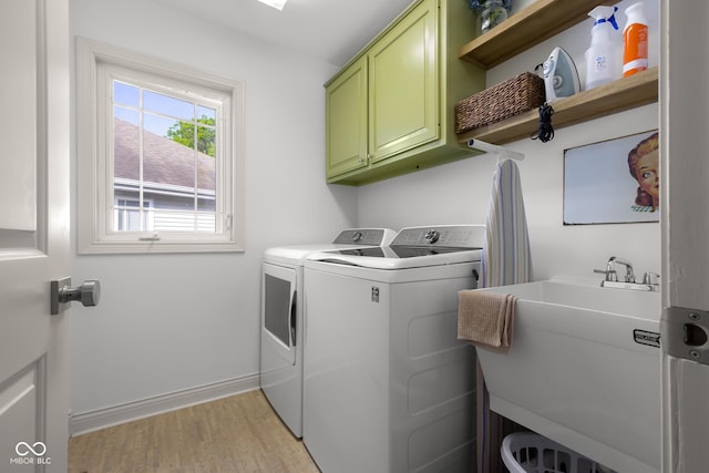 3781 S Station Dr, Columbus, IN 47203 - laundry room featuring cabinet space, separate washer and dryer, light wood-style flooring, and baseboards