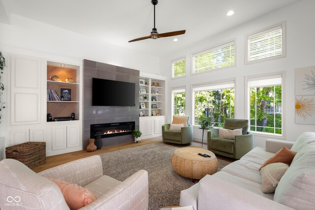 3781 S Station Dr, Columbus, IN 47203 - living area with a ceiling fan, a high ceiling, a fireplace, wood finished floors, and recessed lighting