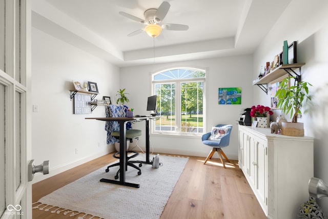 3781 S Station Dr, Columbus, IN 47203 - home office with a raised ceiling, light wood finished floors, ceiling fan, and baseboards
