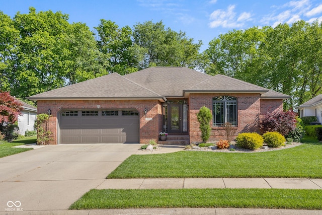 3781 S Station Dr, Columbus, IN 47203 - view of front of home featuring a garage, brick siding, concrete driveway, a front lawn, and a shingled roof