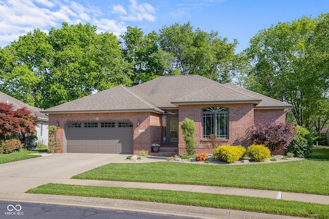3781 S Station Dr, Columbus, IN 47203 - view of front facade featuring a garage, brick siding, and a front lawn