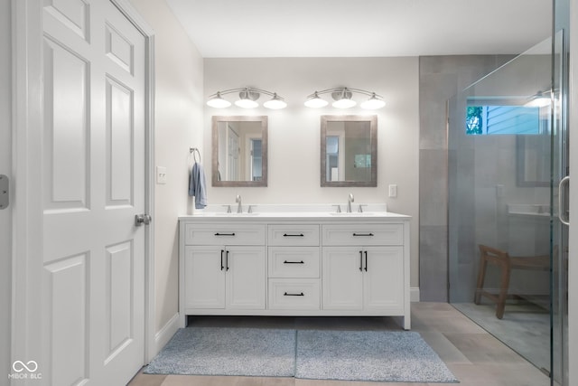 3781 S Station Dr, Columbus, IN 47203 - bathroom featuring double vanity, an enclosed shower, tile patterned flooring, and baseboards