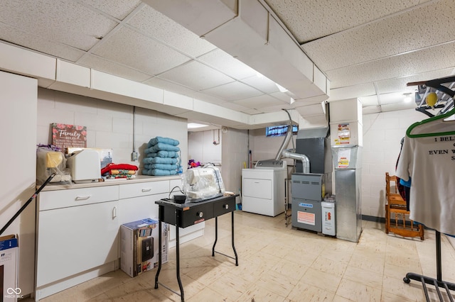 5330 W 56th St, Indianapolis, IN 46254 - finished basement with light floors, a drop ceiling, concrete block wall, heating unit, and washing machine and clothes dryer