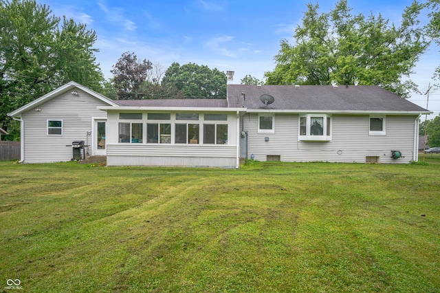 5330 W 56th St, Indianapolis, IN 46254 - back of house with a lawn, a sunroom, and a shingled roof