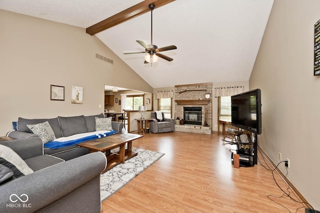551 Windward Ln, Plainfield, IN 46168 - living area with ceiling fan, wood finished floors, high vaulted ceiling, beamed ceiling, and a brick fireplace