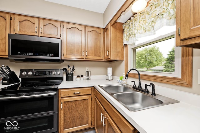 551 Windward Ln, Plainfield, IN 46168 - kitchen with stainless steel appliances, a sink, light countertops, and brown cabinets