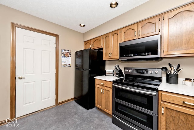 551 Windward Ln, Plainfield, IN 46168 - kitchen with stainless steel appliances, light countertops, and light tile patterned floors