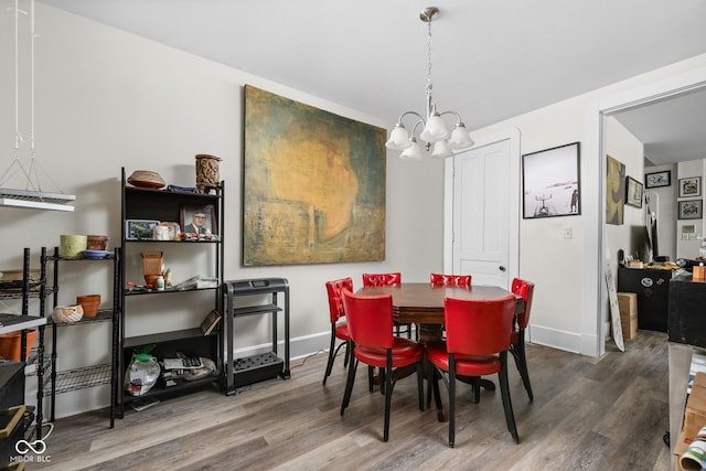 1446 N Illinois St, Indianapolis, IN 46202 - dining room featuring a chandelier, wood finished floors, and baseboards