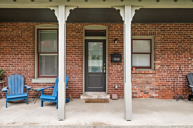 1446 N Illinois St, Indianapolis, IN 46202 - view of exterior entry featuring brick siding and a porch