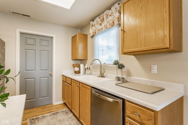 14291 Holly Berry Cir, Fishers, IN 46038 - kitchen featuring dishwasher, a sink, light wood finished floors, and light countertops