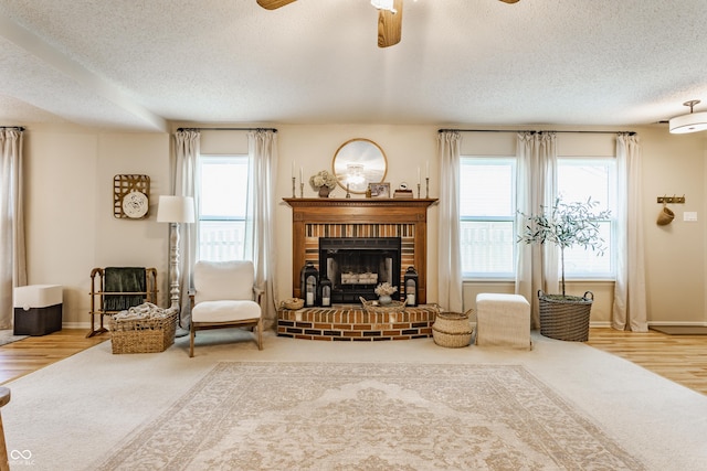14291 Holly Berry Cir, Fishers, IN 46038 - living room with a textured ceiling, plenty of natural light, a brick fireplace, and wood finished floors