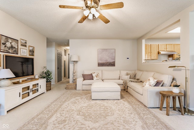 14291 Holly Berry Cir, Fishers, IN 46038 - living room with light carpet, a textured ceiling, a ceiling fan, and baseboards