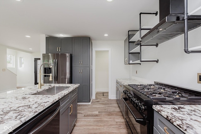 2302 S Pennsylvania St, Indianapolis, IN 46225 - kitchen featuring stainless steel fridge, black range with gas cooktop, dishwashing machine, a sink, and extractor fan
