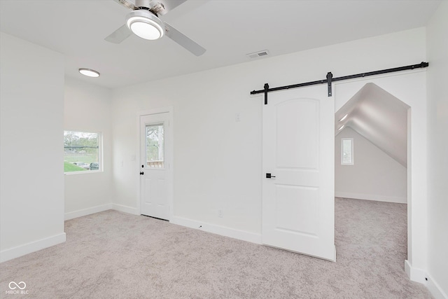 2302 S Pennsylvania St, Indianapolis, IN 46225 - carpeted spare room featuring a ceiling fan, a barn door, and baseboards