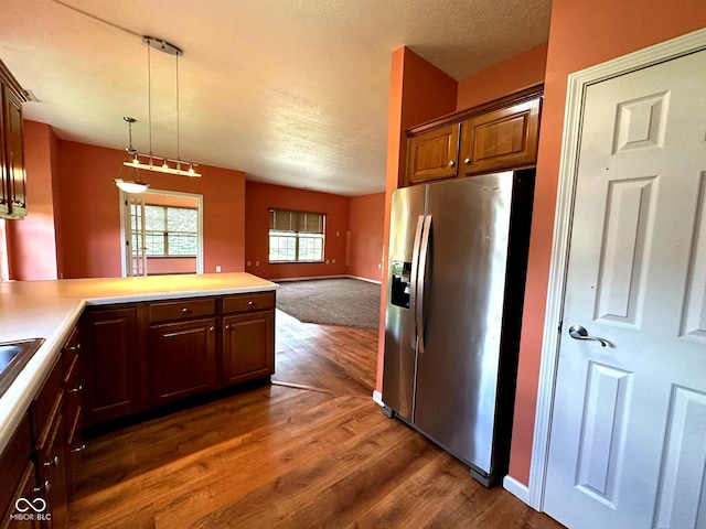 800 Eastfield Dr, Crawfordsville, IN 47933 - kitchen with stainless steel fridge, dark wood-style floors, open floor plan, a peninsula, and light countertops
