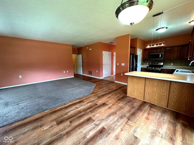 800 Eastfield Dr, Crawfordsville, IN 47933 - kitchen with stainless steel appliances, a sink, wood finished floors, light countertops, and open floor plan