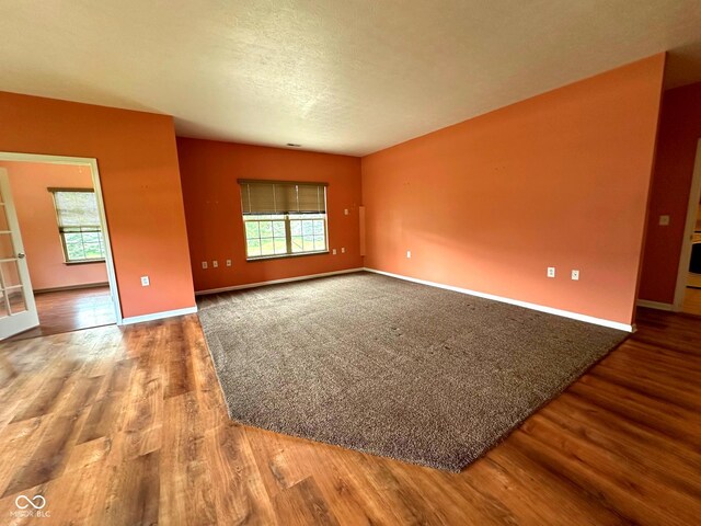 800 Eastfield Dr, Crawfordsville, IN 47933 - unfurnished room featuring wood finished floors, healthy amount of natural light, baseboards, and a textured ceiling