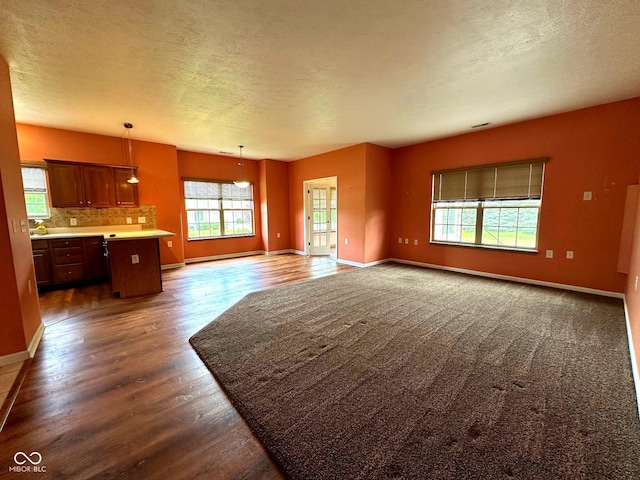 800 Eastfield Dr, Crawfordsville, IN 47933 - unfurnished living room with dark wood-style floors, baseboards, and a textured ceiling