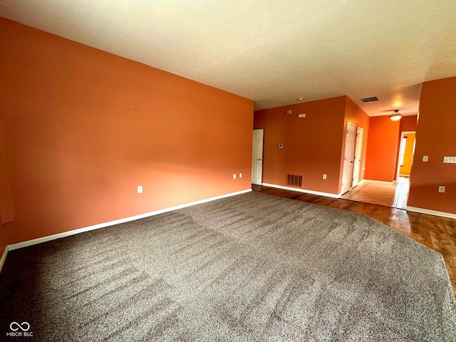 800 Eastfield Dr, Crawfordsville, IN 47933 - empty room featuring carpet flooring, baseboards, wood finished floors, and a textured ceiling