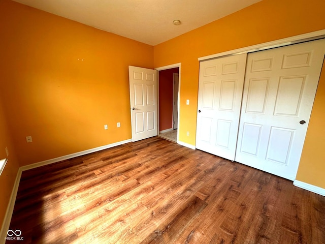 800 Eastfield Dr, Crawfordsville, IN 47933 - unfurnished bedroom with wood finished floors, a closet, and baseboards