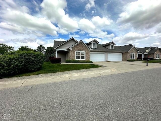 800 Eastfield Dr, Crawfordsville, IN 47933 - view of front facade featuring brick siding, driveway, an attached garage, and a front lawn