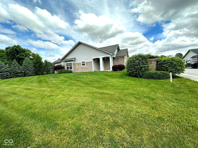 800 Eastfield Dr, Crawfordsville, IN 47933 - view of side of property with a lawn and brick siding