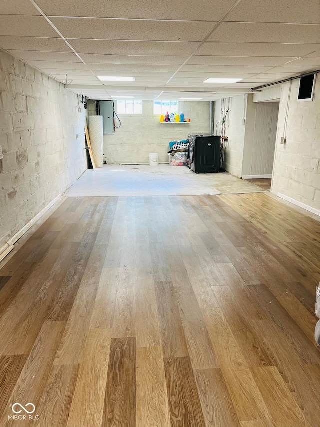 4850 E University Ave, Indianapolis, IN 46201 - below grade area with light wood-type flooring, electric panel, a drop ceiling, and a wood stove