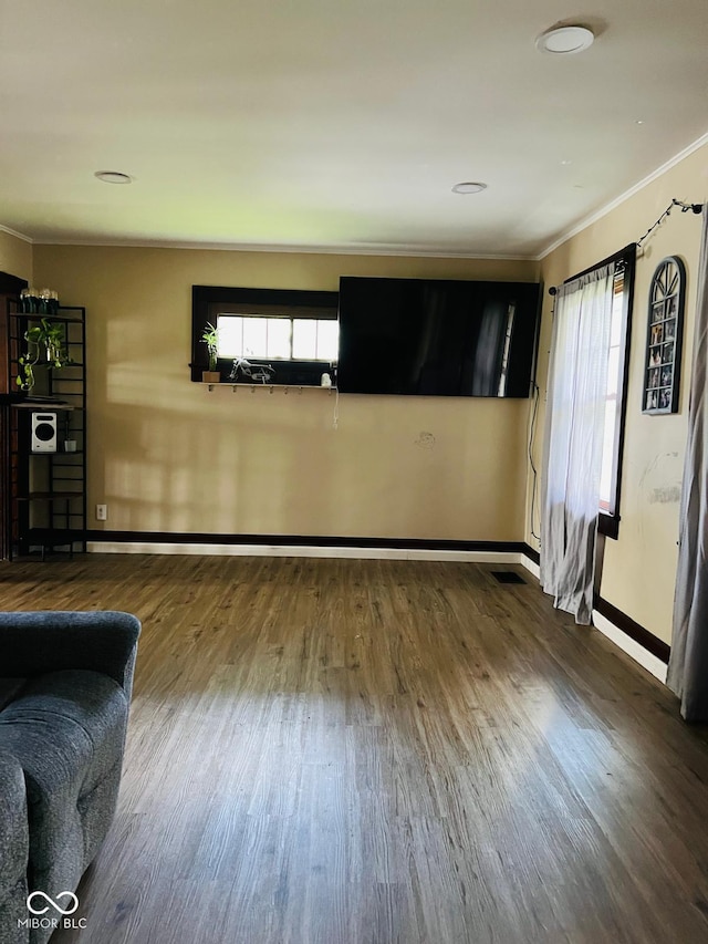 4850 E University Ave, Indianapolis, IN 46201 - unfurnished living room with ornamental molding, wood finished floors, and baseboards