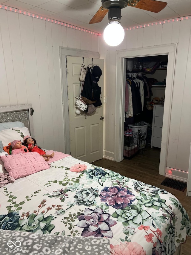 4850 E University Ave, Indianapolis, IN 46201 - bedroom with wood finished floors, a closet, a ceiling fan, and a walk in closet