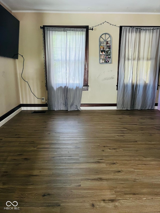 4850 E University Ave, Indianapolis, IN 46201 - unfurnished living room featuring wood finished floors, baseboards, and crown molding