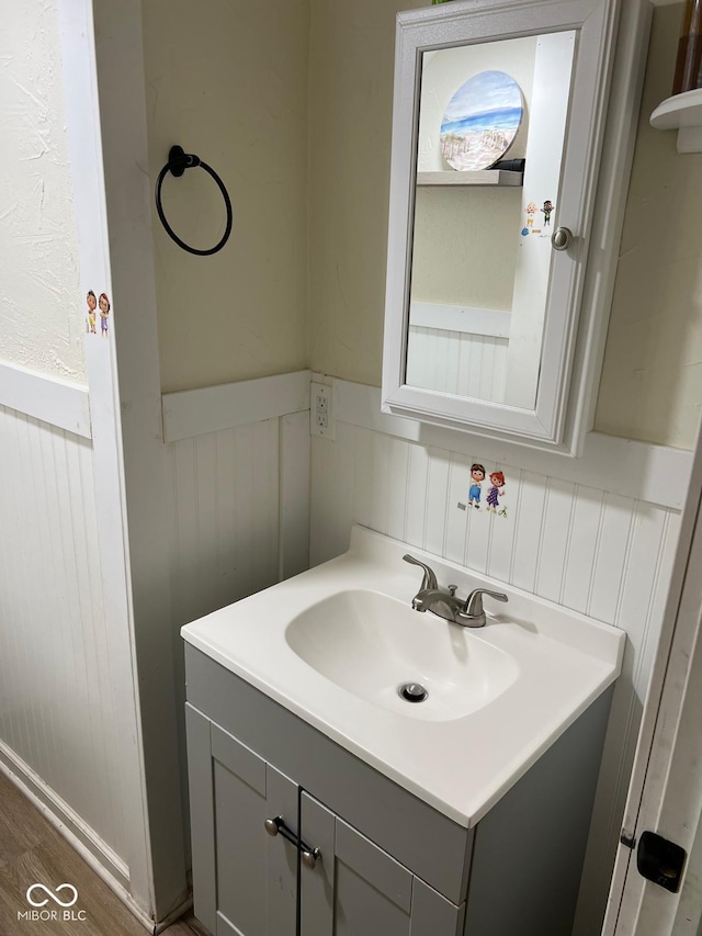 4850 E University Ave, Indianapolis, IN 46201 - bathroom with a wainscoted wall, vanity, and wood finished floors