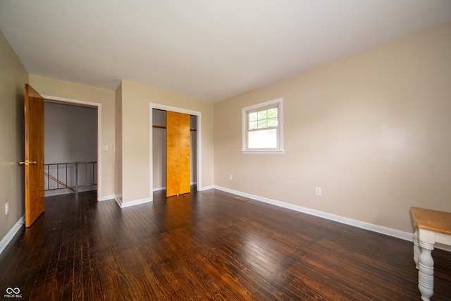 5388 W Hazelrigg Rd, Thorntown, IN 46071 - unfurnished bedroom with baseboards, dark wood-type flooring, and a closet