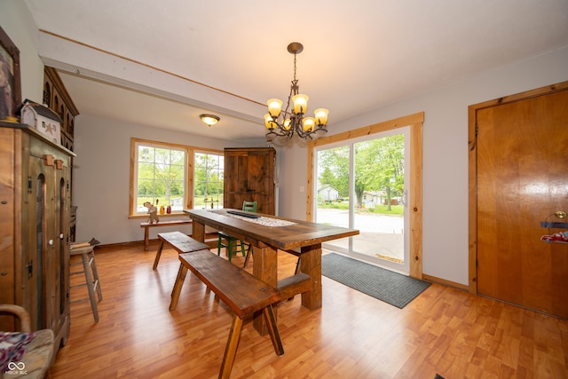 5388 W Hazelrigg Rd, Thorntown, IN 46071 - dining area featuring a chandelier, light wood-style flooring, and baseboards