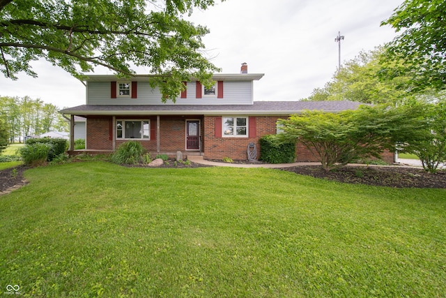 5388 W Hazelrigg Rd, Thorntown, IN 46071 - traditional-style home featuring a chimney, a front yard, and brick siding