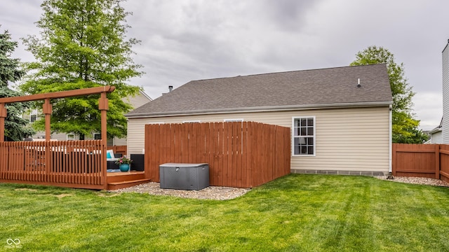 rear view of property featuring a wooden deck, central AC, and a shingled roof