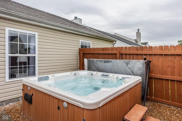 wooden deck with fence and a hot tub