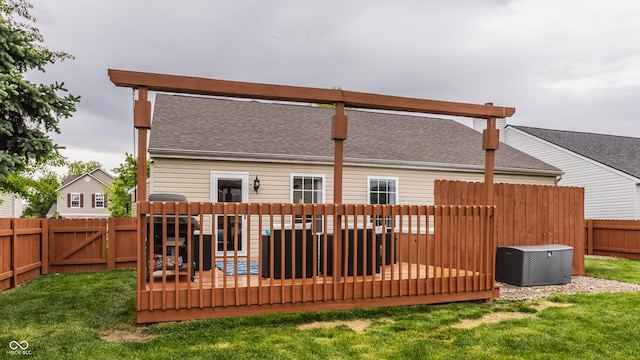 back of property featuring a wooden deck, a shingled roof, and central AC