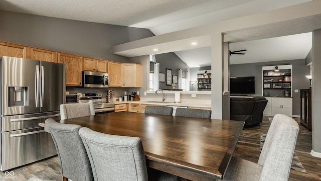 dining space with lofted ceiling, dark wood-type flooring, ceiling fan, and recessed lighting