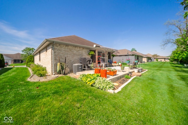 188 Bay Ridge Dr, Pendleton, IN 46064 - rear view of property with a patio area, cooling unit, a lawn, and brick siding