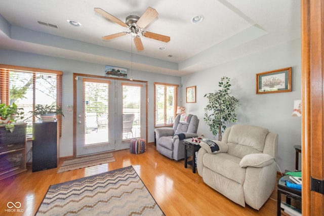188 Bay Ridge Dr, Pendleton, IN 46064 - living area with light wood-style flooring, a ceiling fan, a tray ceiling, and recessed lighting