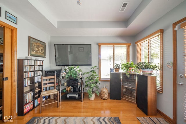 188 Bay Ridge Dr, Pendleton, IN 46064 - living area with wood finished floors, a raised ceiling, and baseboards