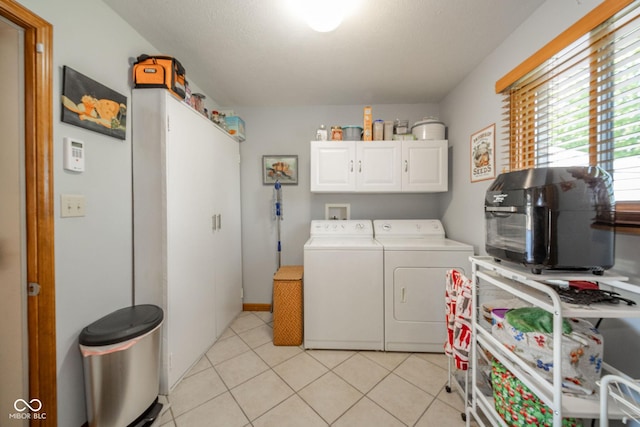 188 Bay Ridge Dr, Pendleton, IN 46064 - laundry area featuring cabinet space, washing machine and dryer, and light tile patterned floors