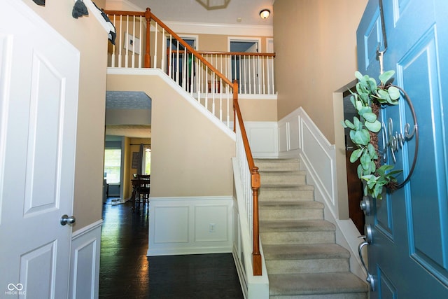 11727 Wedgeport Ln, Fishers, IN 46037 - stairway with a decorative wall, wainscoting, wood finished floors, a towering ceiling, and ornamental molding