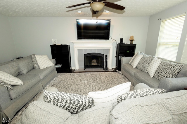 11727 Wedgeport Ln, Fishers, IN 46037 - living room featuring a ceiling fan, a tile fireplace, and a textured ceiling