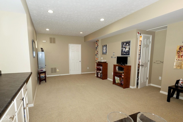 11727 Wedgeport Ln, Fishers, IN 46037 - living room with light colored carpet, recessed lighting, baseboards, and a textured ceiling